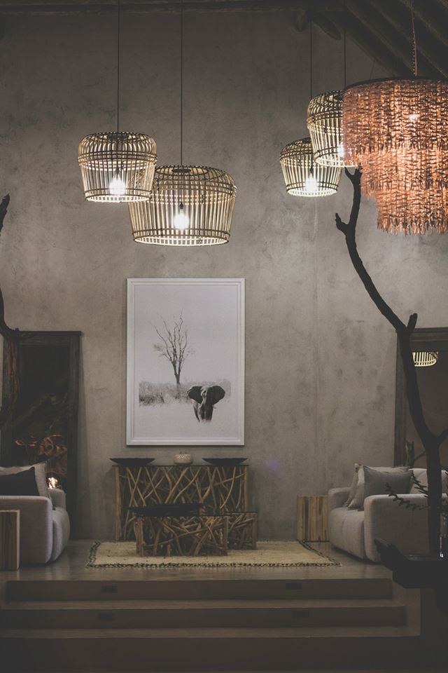 Elegant living area with wicker pendant lights and framed elephant artwork