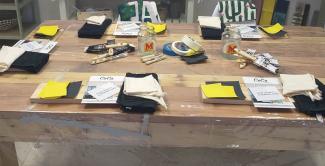 Workshop table with painting tools and supplies prepared for a class